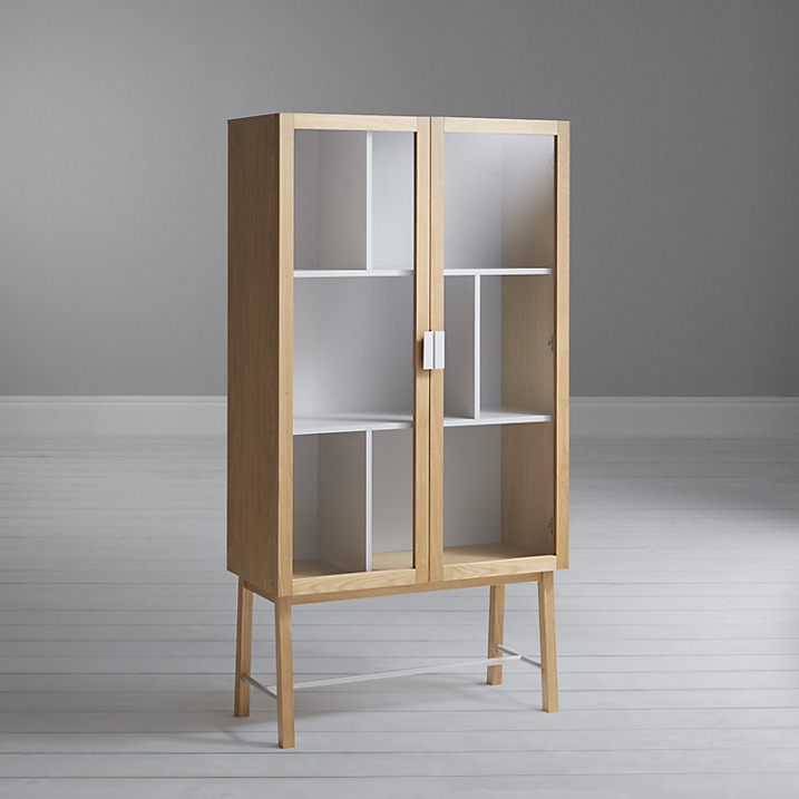 A contemporary display cabinet perfect for showcasing decorative items and storing books. The open base gives a light feel for a more open visual space.